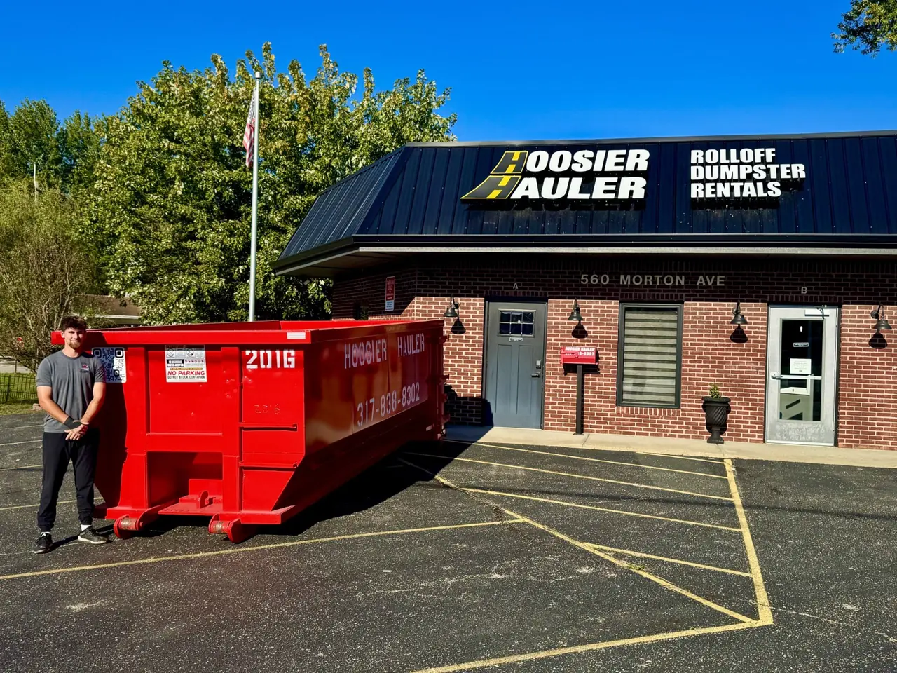 Dumpster Rental Software: The Complete Guide for Modern Haulers (2026) — 20-yard red roll-off dumpster outside the Hoosier Hauler office on Morton Avenue