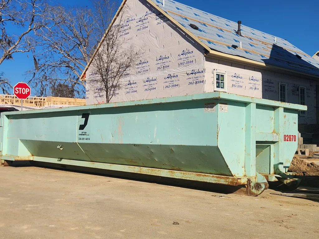 Mint green Jettson Environmental roll-off staged at an active new-build construction site. Photo courtesy of Jettson Environmental.