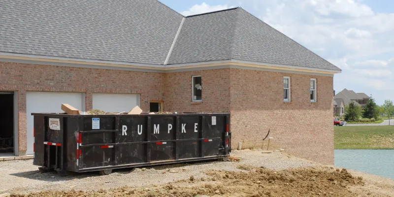 Rumpke commercial roll-off dumpster on a new home build job site. Photo courtesy of Rumpke Waste & Recycling.